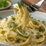 Garlic butter noodles in a plate, tossed and ready to serve.