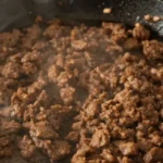 Top-down view of cast iron skillet with browned ground beef for carnivore diet ground beef recipes