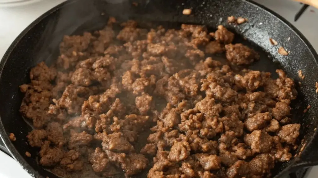 Top-down view of cast iron skillet with browned ground beef for carnivore diet ground beef recipes
