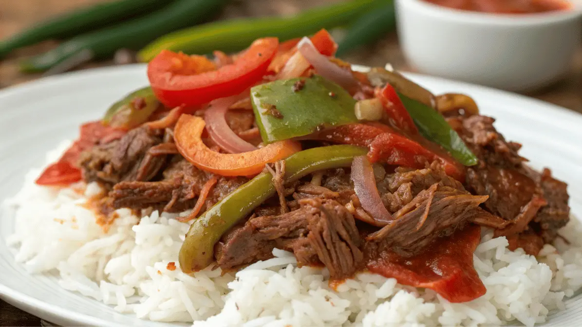 Tender shredded beef with peppers and onions served over white rice – ropa vieja recipe slow cooker