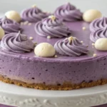 Beautifully styled ube cheesecake recipe with whipped cream and ube toppings.
