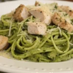 Plate of zucchini noodles with grilled chicken and homemade pesto