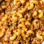 Plate of Homemade Hamburger Helper with pasta, beef, and melted cheese.