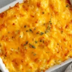 Top-down view of Overnight Christmas Hashbrown Casserole golden and cheesy in a white baking dish